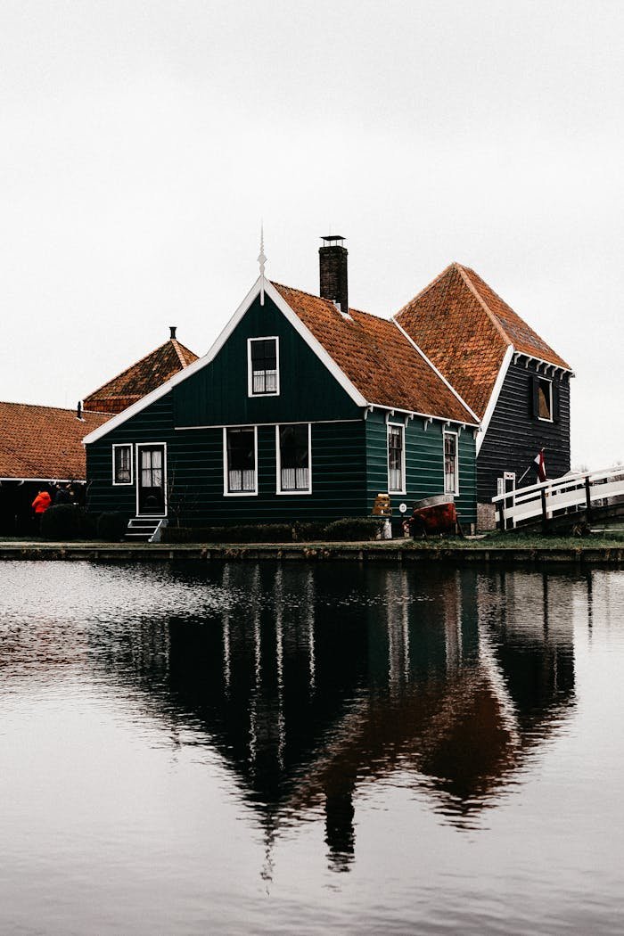 Green Wooden House with Brown Roof